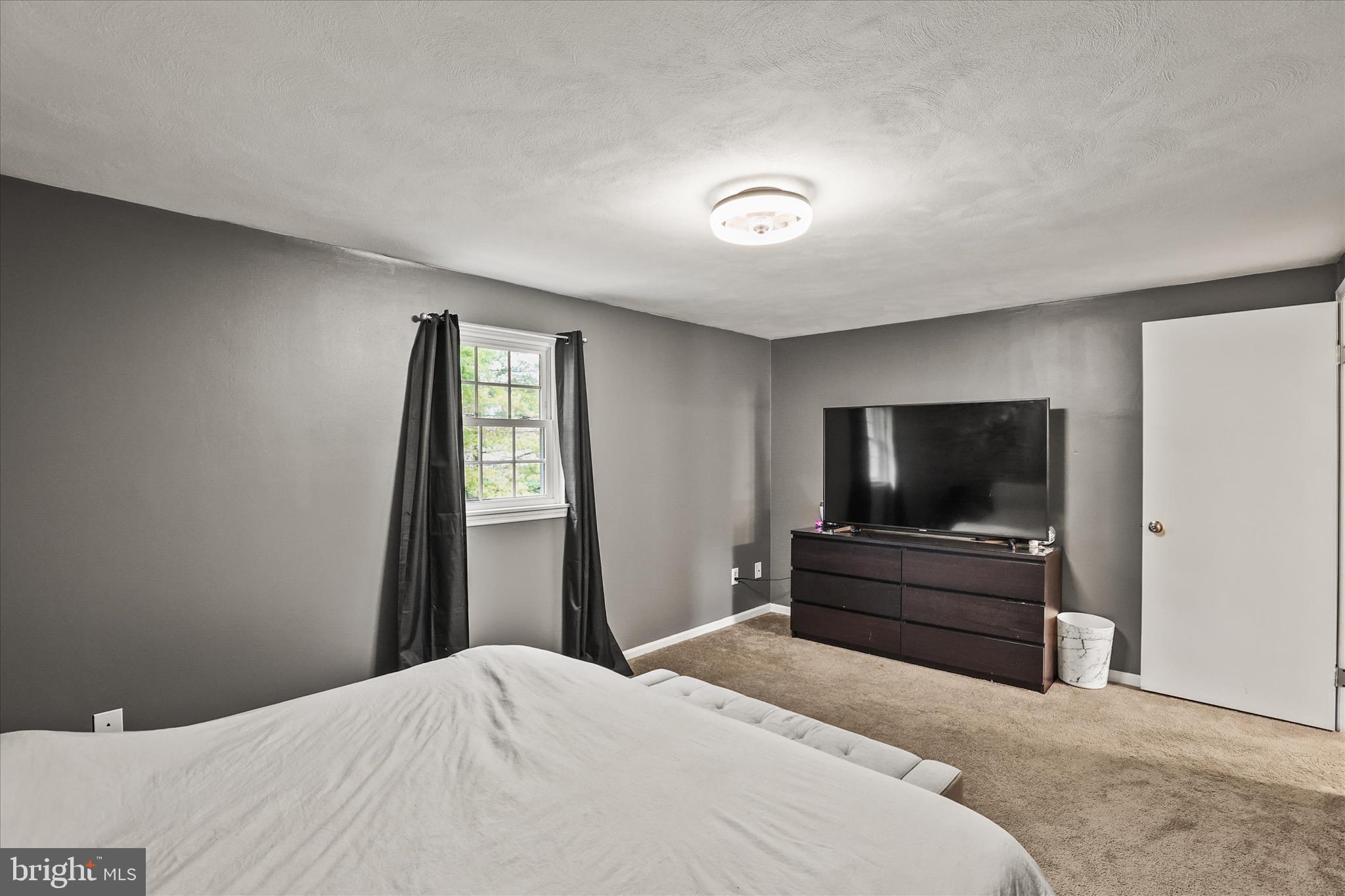 451 Weldon Drive, Unit 451 York, PA 17404 - Photo 16 of 38 a bedroom with a bed and a flat screen tv