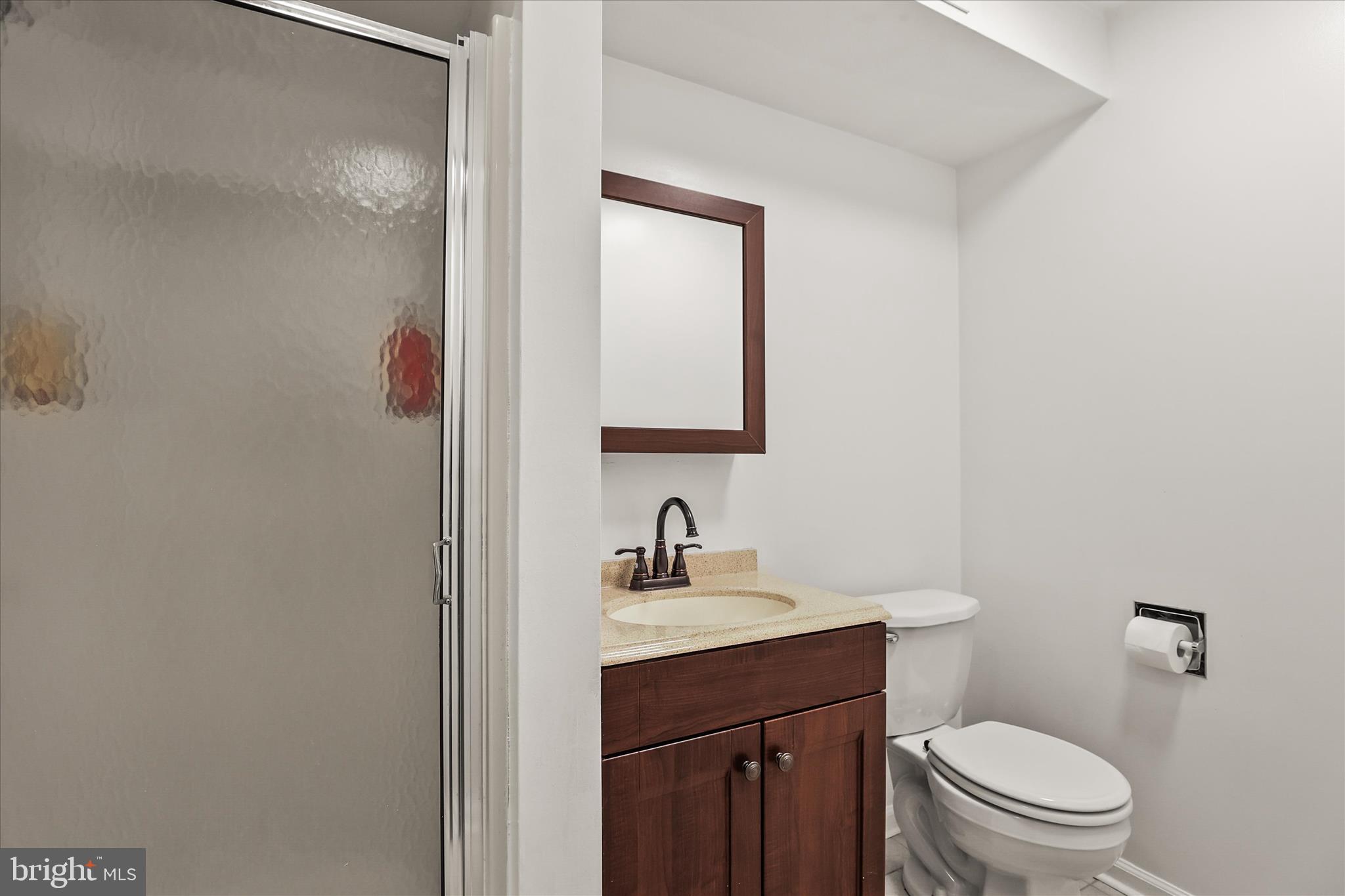451 Weldon Drive, Unit 451 York, PA 17404 - Photo 24 of 38 a bathroom with a toilet sink and mirror