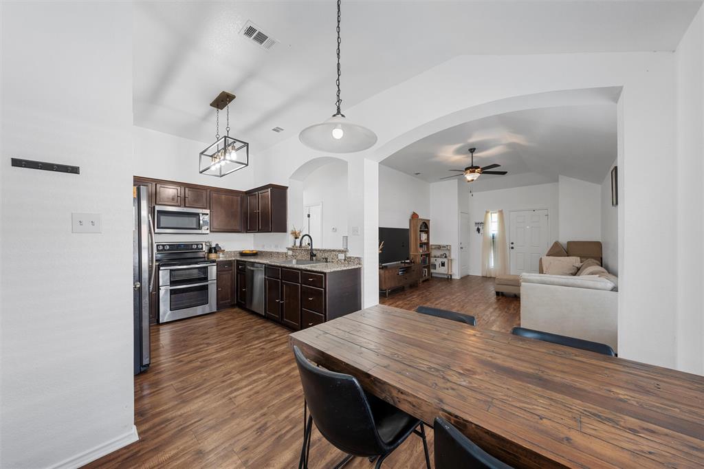 4321 South Fork Ranch Road Waco, TX 76705 - Photo 16 of 17 a large kitchen with cabinets wooden floor and stainless steel appliances