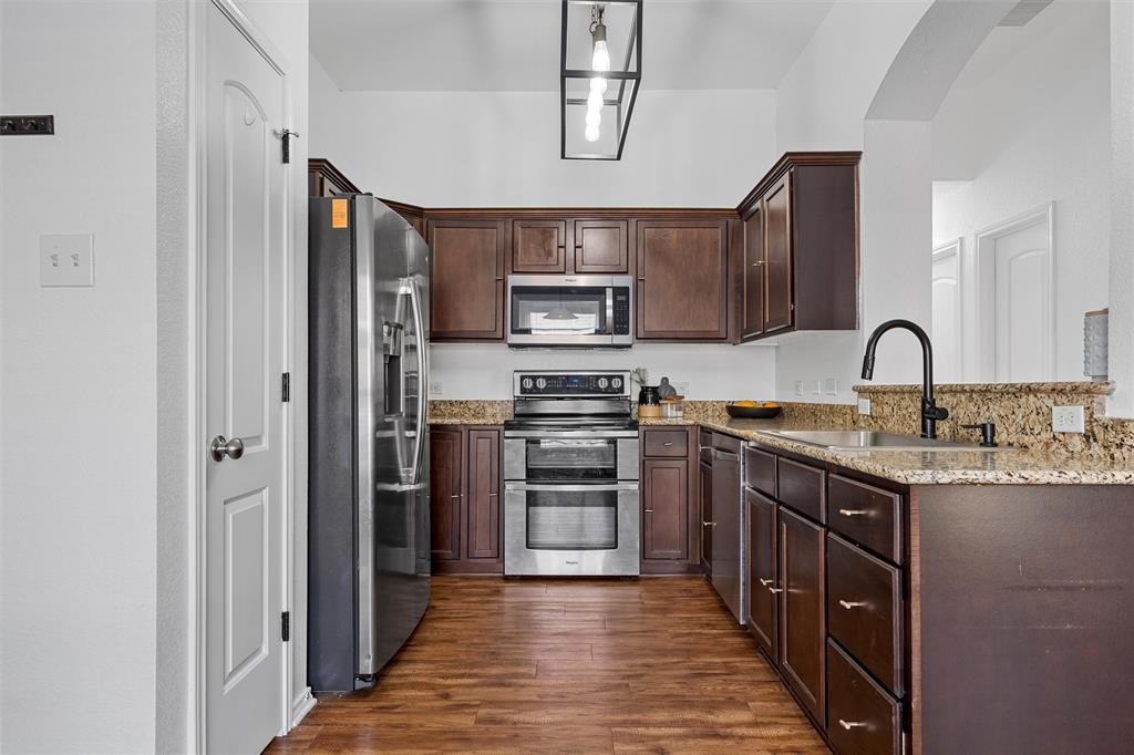 4321 South Fork Ranch Road Waco, TX 76705 - Photo 12 of 17 a kitchen with stainless steel appliances granite countertop a stove top oven a sink and dishwasher