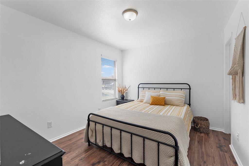 4321 South Fork Ranch Road Waco, TX 76705 - Photo 2 of 17 a bedroom with a bed and wooden floor