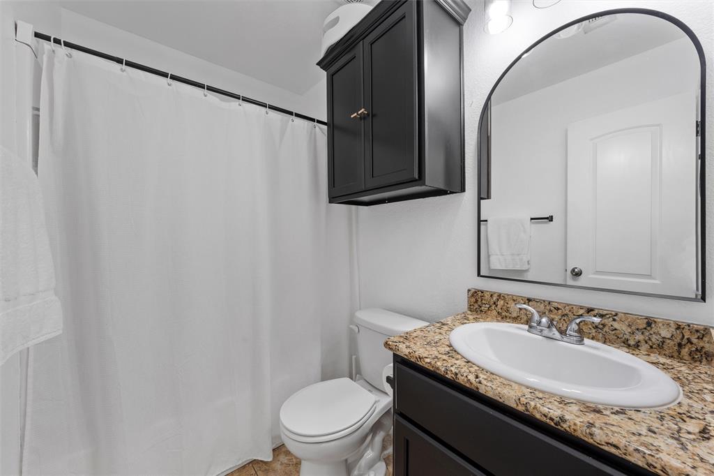 4321 South Fork Ranch Road Waco, TX 76705 - Photo 3 of 17 a bathroom with a granite countertop sink and a mirror
