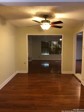 a view of hallway with wooden floor