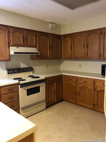 a kitchen with cabinets a sink and a stove