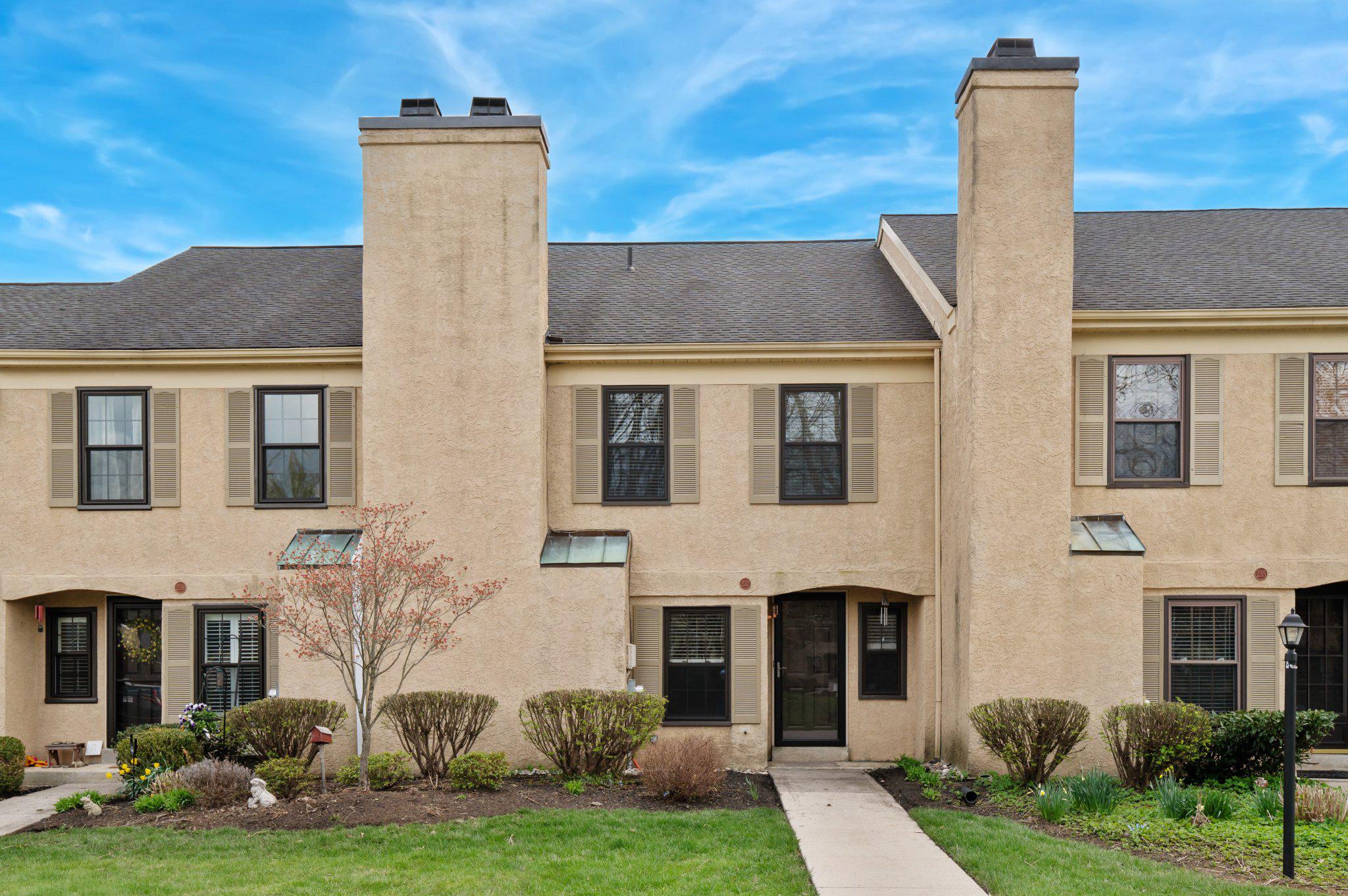 a front view of a house with garden