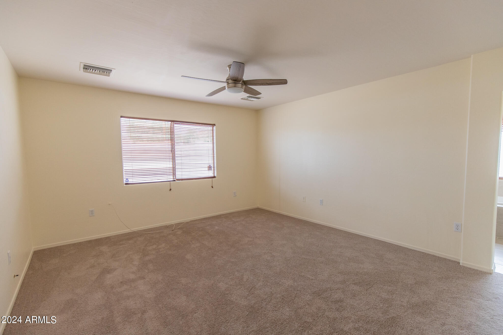 9013 North 14th Street Phoenix, AZ 85020 - Photo 10 of 24 an empty room with windows and fan