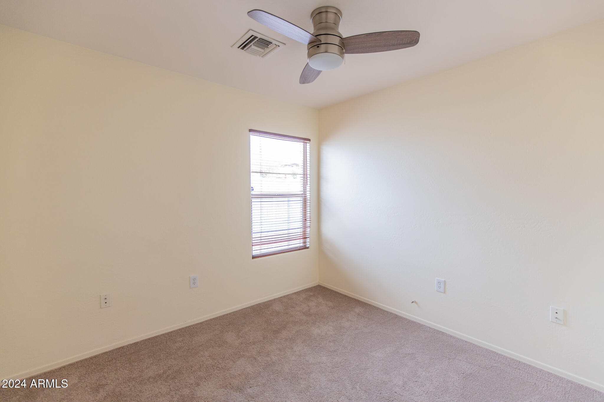9013 North 14th Street Phoenix, AZ 85020 - Photo 15 of 24 an empty room with a window and ceiling fan
