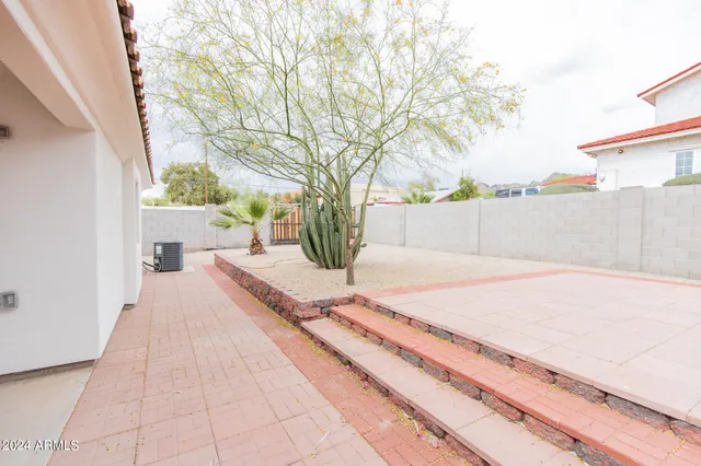 a view of a chair and table in the backyard