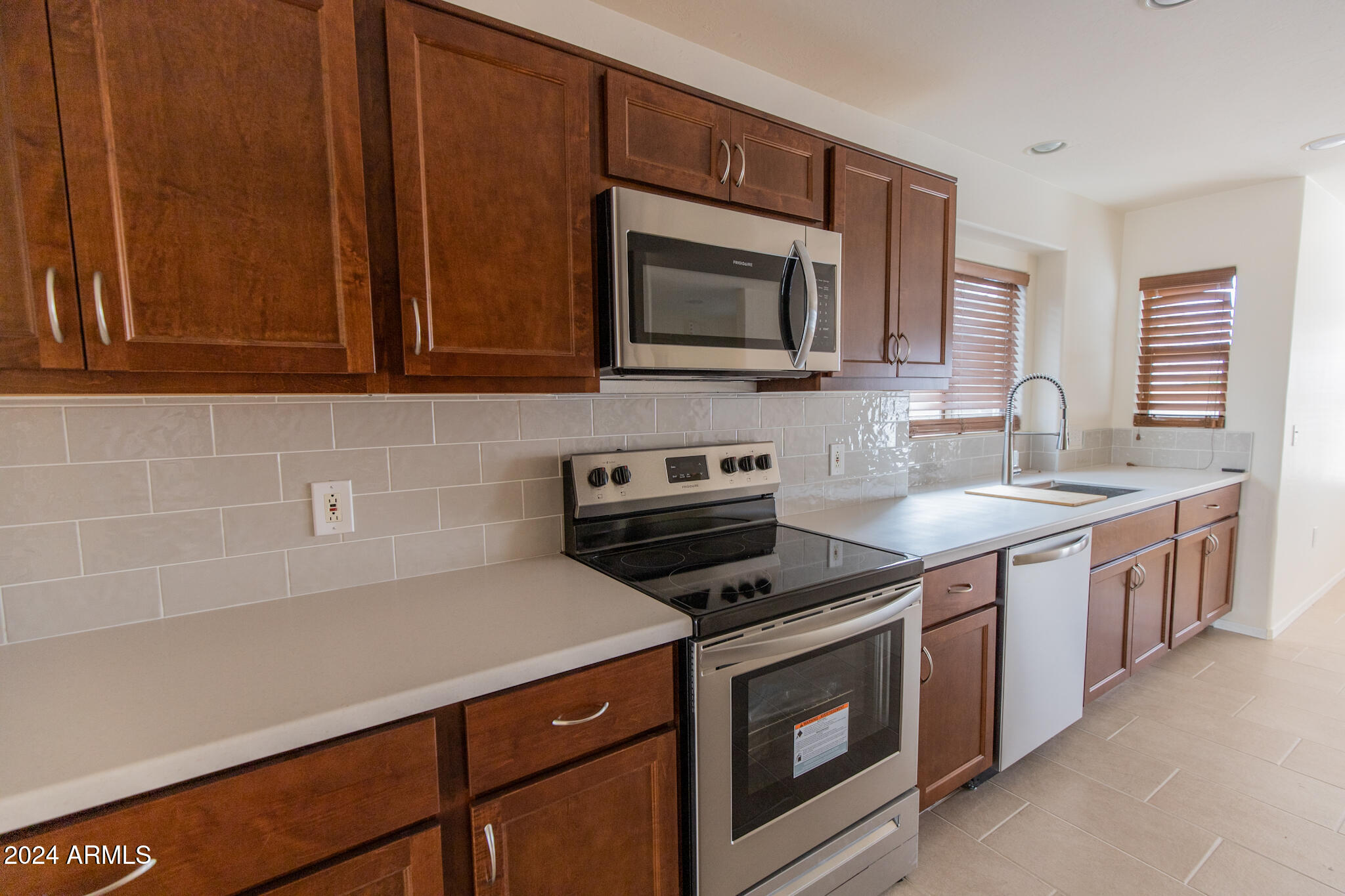 9013 North 14th Street Phoenix, AZ 85020 - Photo 2 of 24 a kitchen with stainless steel appliances a stove microwave and sink