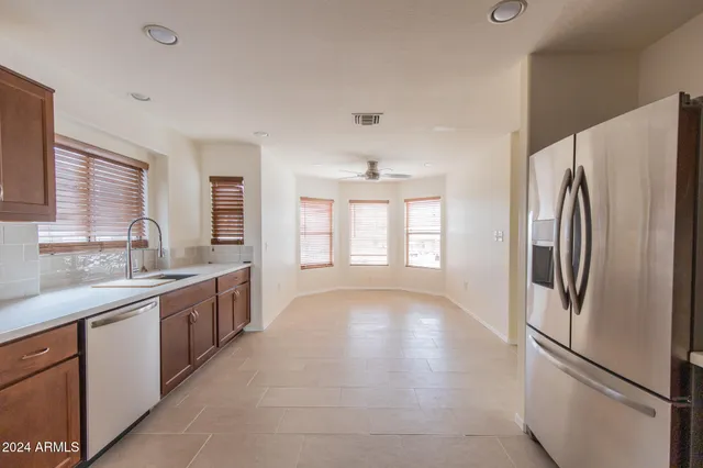 a kitchen with stainless steel appliances a refrigerator sink and cabinets