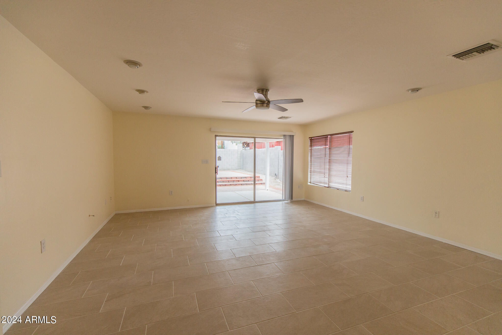 9013 North 14th Street Phoenix, AZ 85020 - Photo 9 of 24 an empty room with windows and chandelier fan
