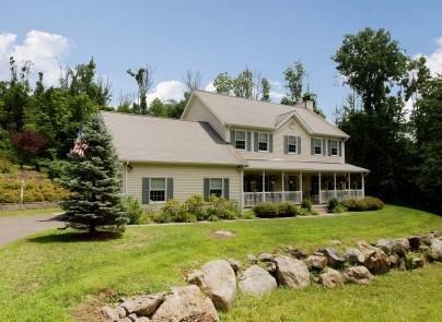 240 Ridgebury Road Ridgefield, CT 06877 - Photo 1 of 1 a front view of a house with garden