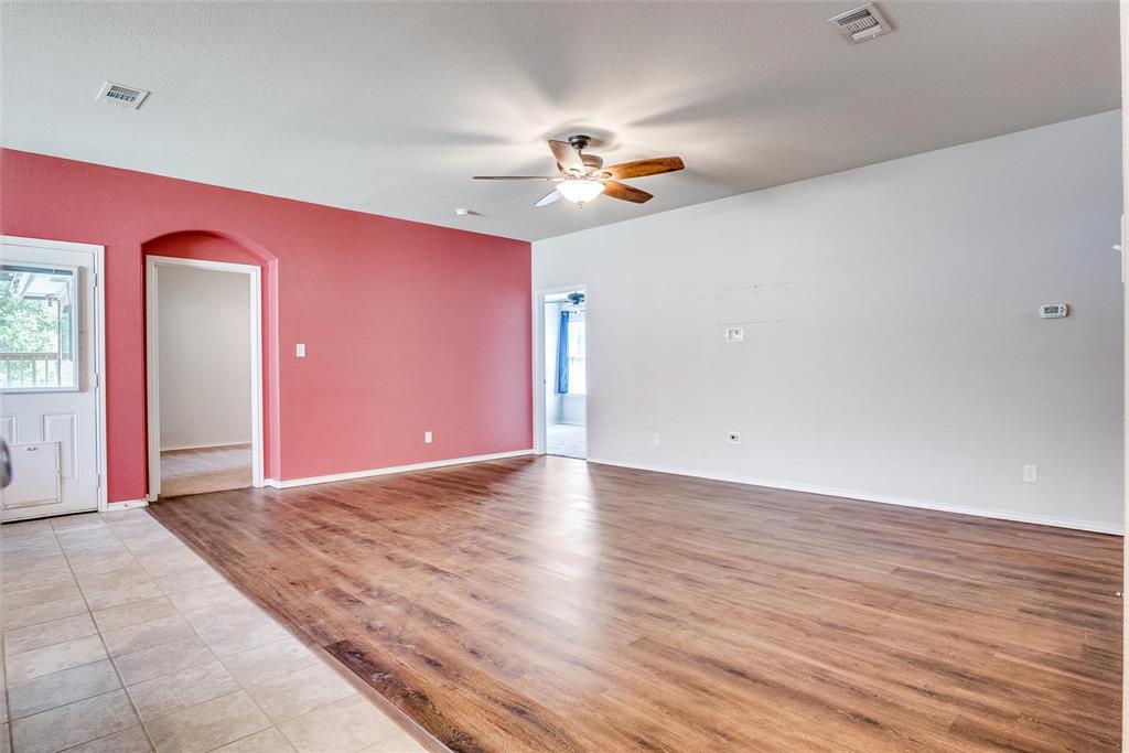 227 Walnut Bend Road Springtown, TX 76082 - Photo 12 of 31 a view of an empty room with wooden floor