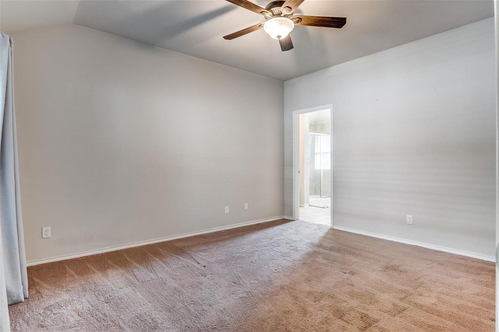 227 Walnut Bend Road Springtown, TX 76082 - Photo 14 of 31 an empty room with a chandelier fan and windows