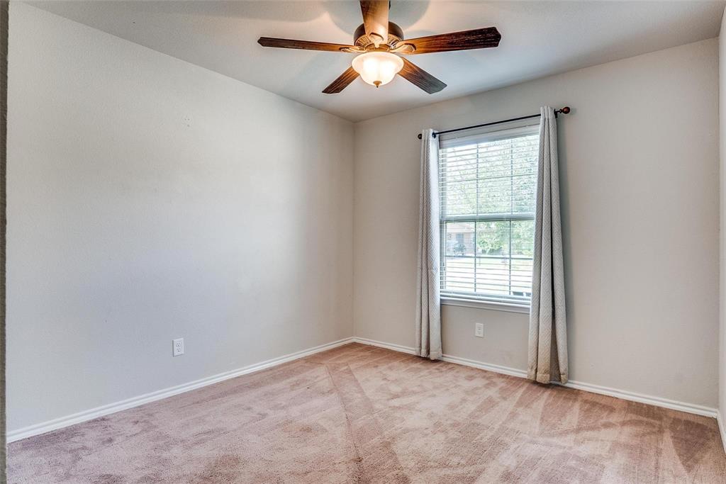 227 Walnut Bend Road Springtown, TX 76082 - Photo 18 of 31 an empty room with chandelier fan and windows