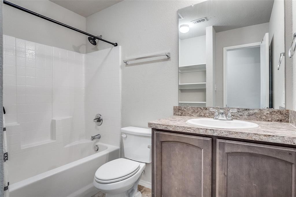 227 Walnut Bend Road Springtown, TX 76082 - Photo 22 of 31 a bathroom with a granite countertop sink toilet and shower