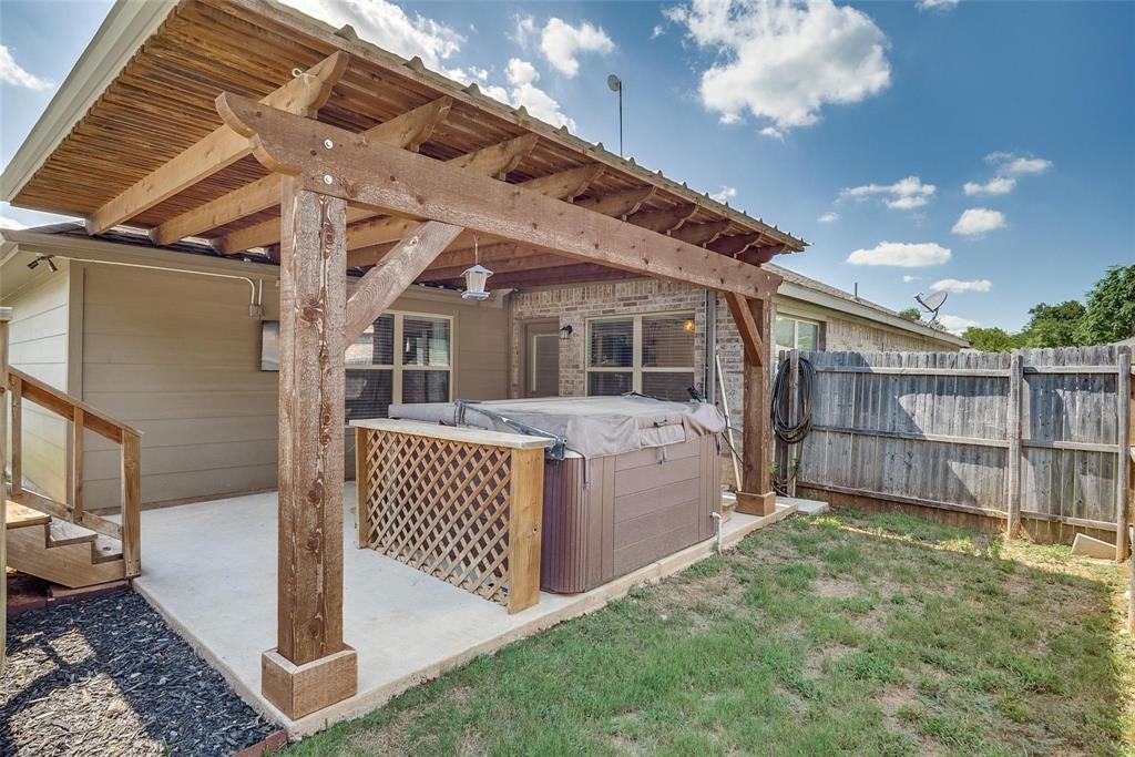 227 Walnut Bend Road Springtown, TX 76082 - Photo 28 of 31 a view of a backyard with wooden fence