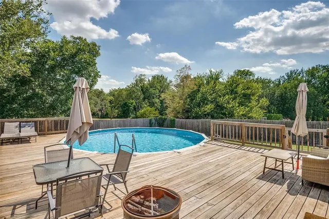 a view of a house with a backyard and a patio