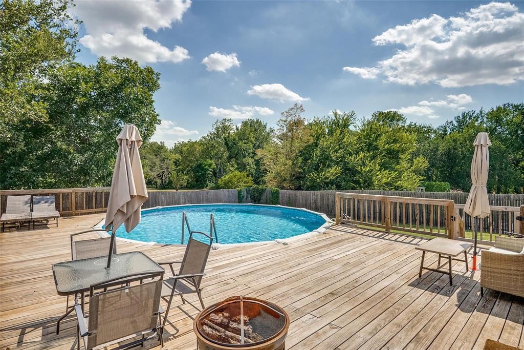 227 Walnut Bend Road Springtown, TX 76082 - Photo 29 of 31 a view of balcony with wooden floor and outdoor seating