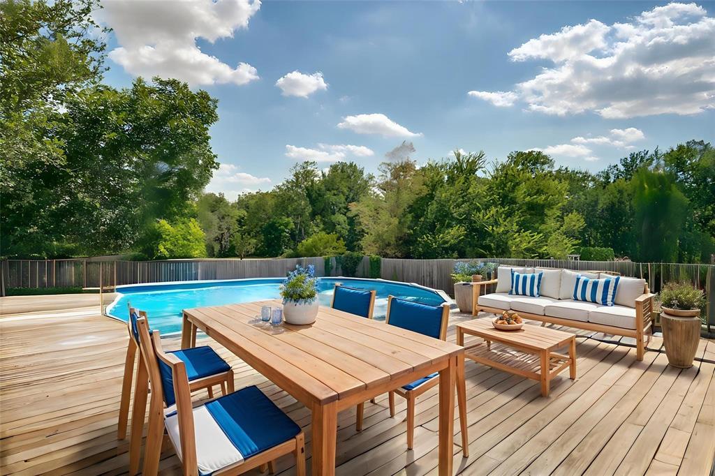 227 Walnut Bend Road Springtown, TX 76082 - Photo 4 of 31 a roof deck with a dining table and chairs with wooden floor