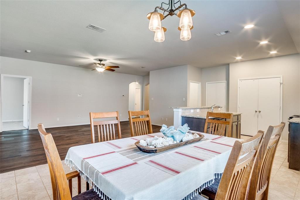 227 Walnut Bend Road Springtown, TX 76082 - Photo 5 of 31 a view of a dining room with furniture a chandelier and wooden floor