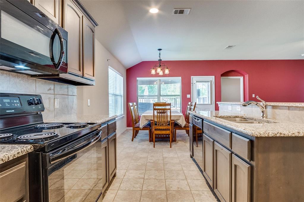 227 Walnut Bend Road Springtown, TX 76082 - Photo 9 of 31 a kitchen with stainless steel appliances granite countertop a stove a sink and dishwasher
