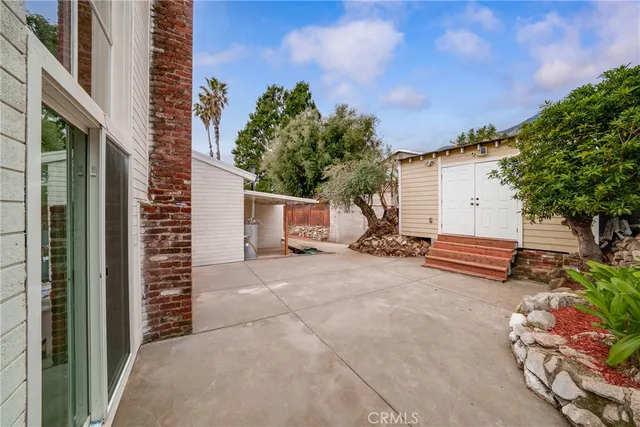 a view of a house with a yard and tree s