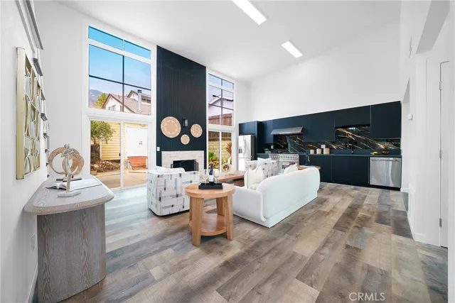 a living room with fireplace furniture and a large window