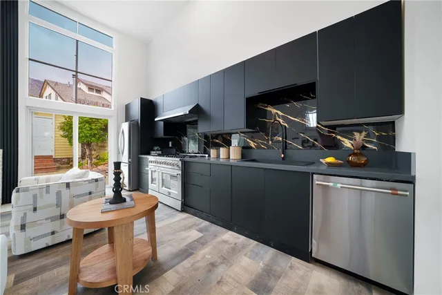 a kitchen with a sink appliances and cabinets