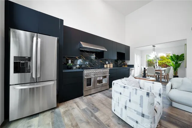 a kitchen with stainless steel appliances a refrigerator and a stove top oven