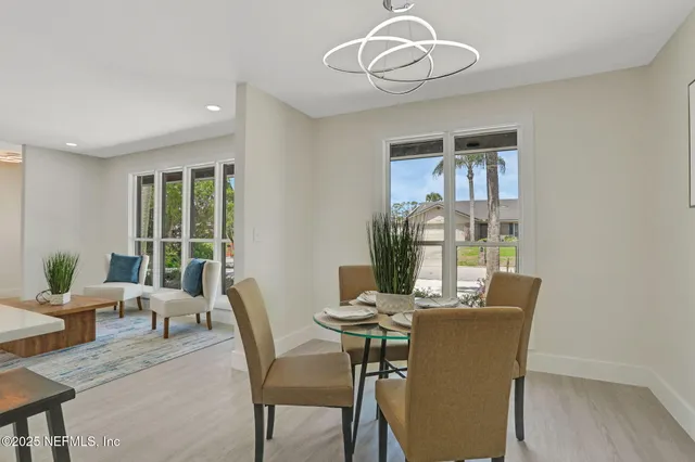a view of a dining room with furniture wooden floor and chandelier