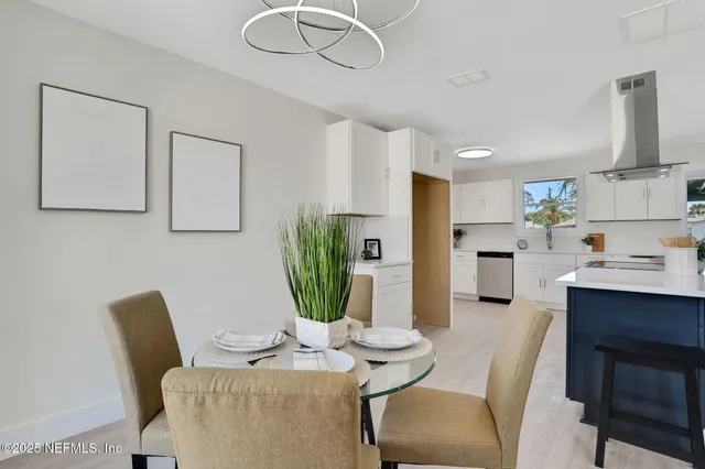 a view of kitchen with furniture and a potted plant