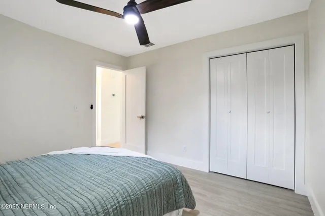 a bedroom with a bed and wooden floor