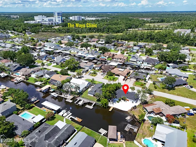 an aerial view of residential houses with outdoor space
