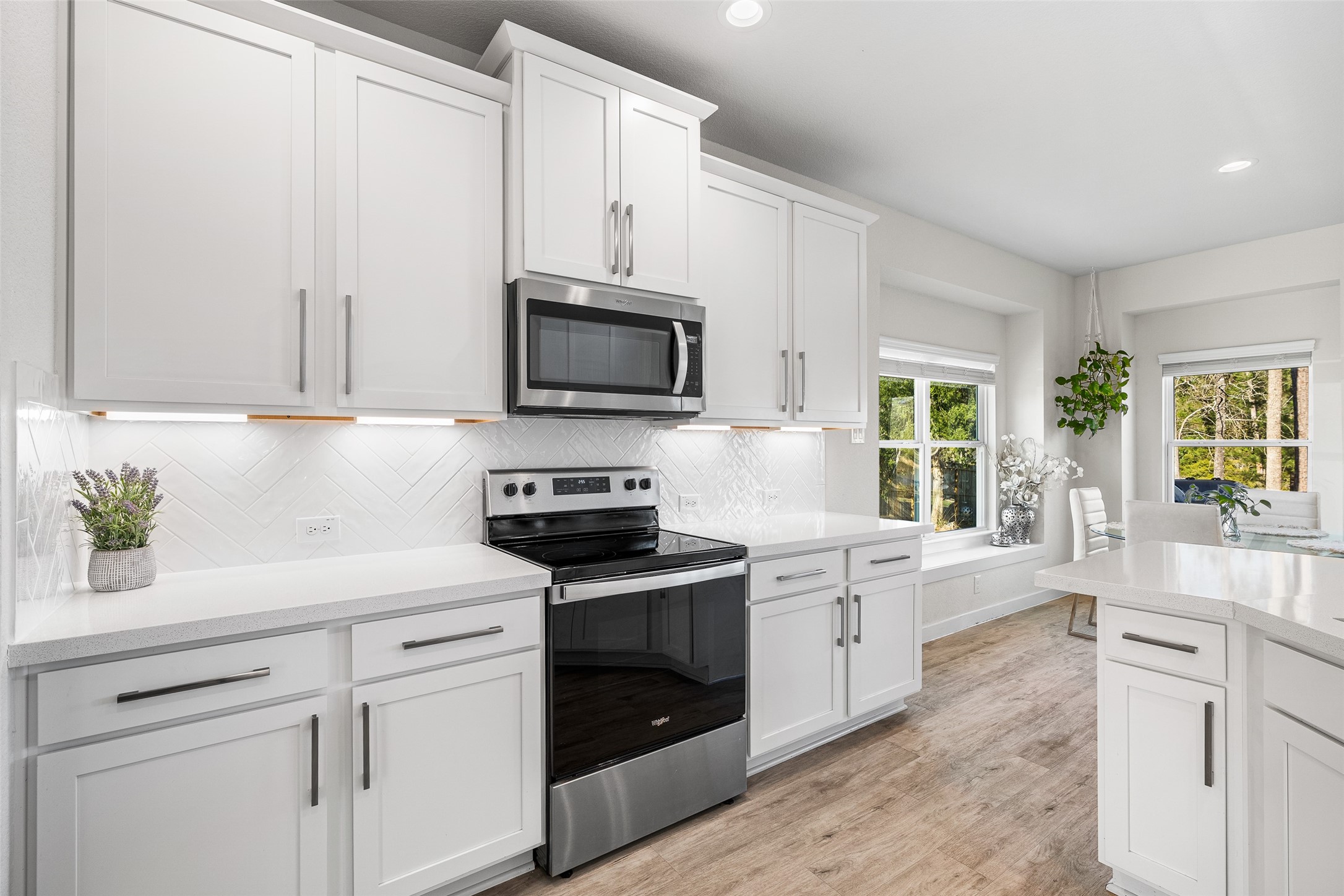 11731 Oakwood Rnch Drive Willis, TX 77378 - Photo 13 of 43 a kitchen with white cabinets and appliances