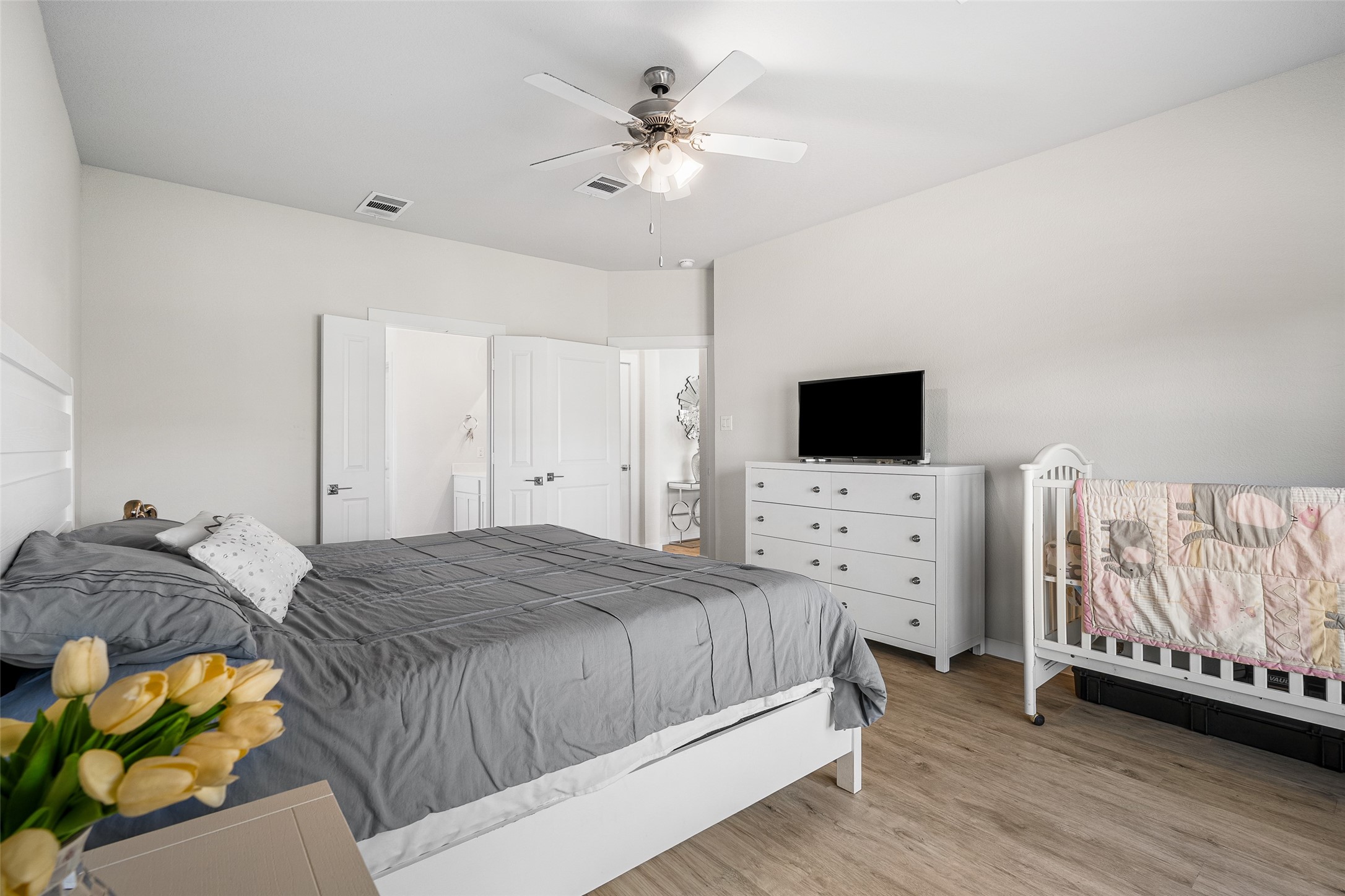 11731 Oakwood Rnch Drive Willis, TX 77378 - Photo 21 of 43 a bedroom with a bed and a flat screen tv