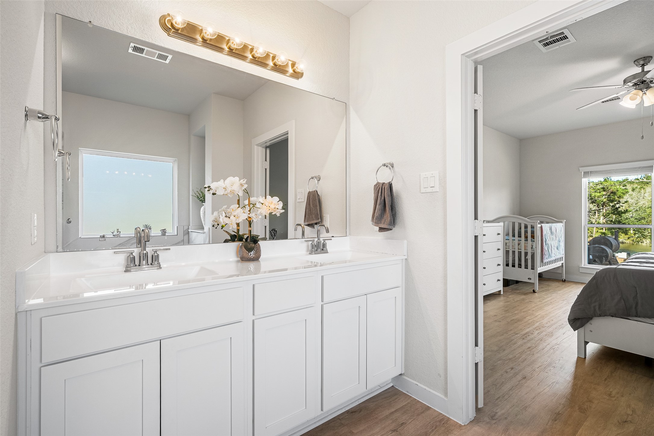 11731 Oakwood Rnch Drive Willis, TX 77378 - Photo 22 of 43 a en suite bathroom with a double vanity sink and a mirror