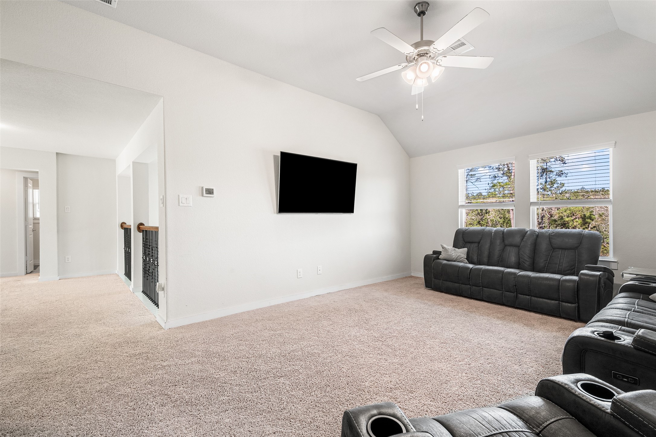 11731 Oakwood Rnch Drive Willis, TX 77378 - Photo 27 of 43 a living room with furniture and a flat screen tv