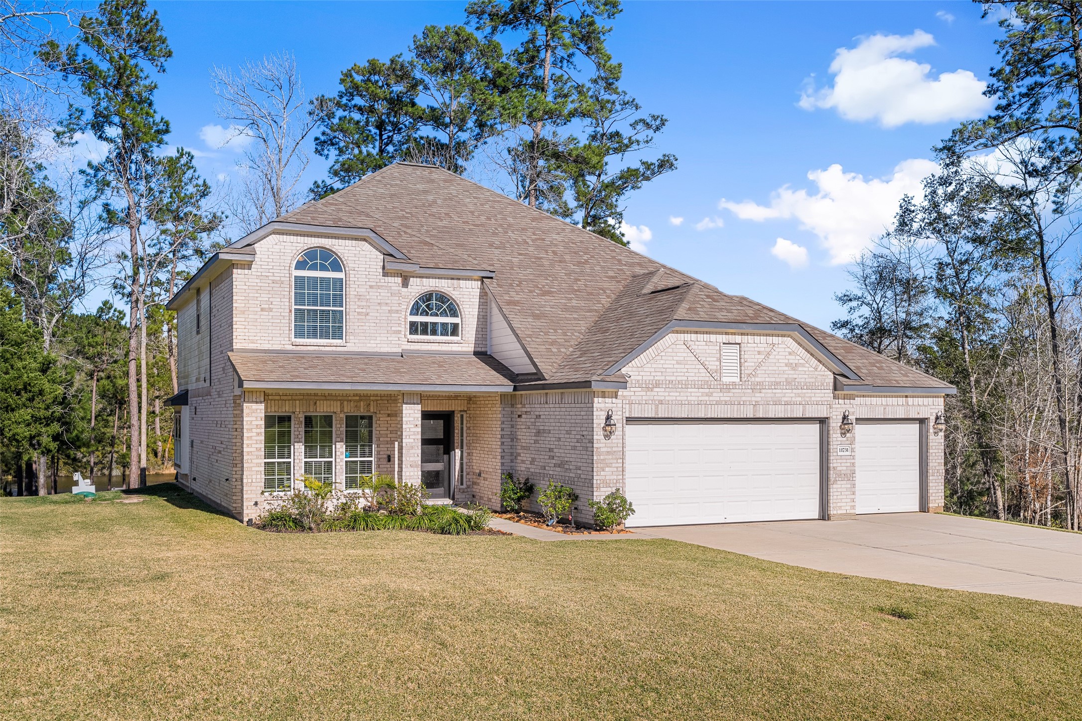 11731 Oakwood Rnch Drive Willis, TX 77378 - Photo 4 of 43 a front view of a house with a garden