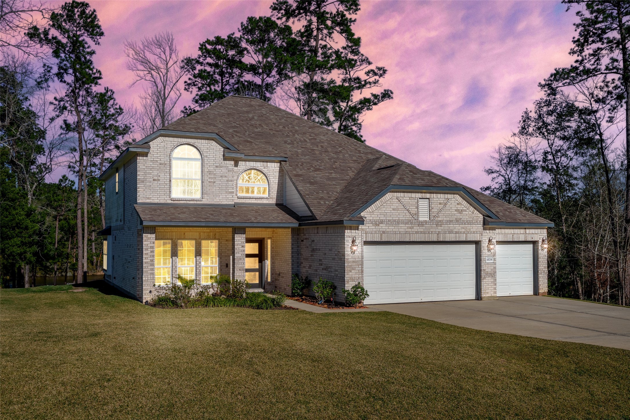 11731 Oakwood Rnch Drive Willis, TX 77378 - Photo 43 of 43 a front view of a house with a yard and garage