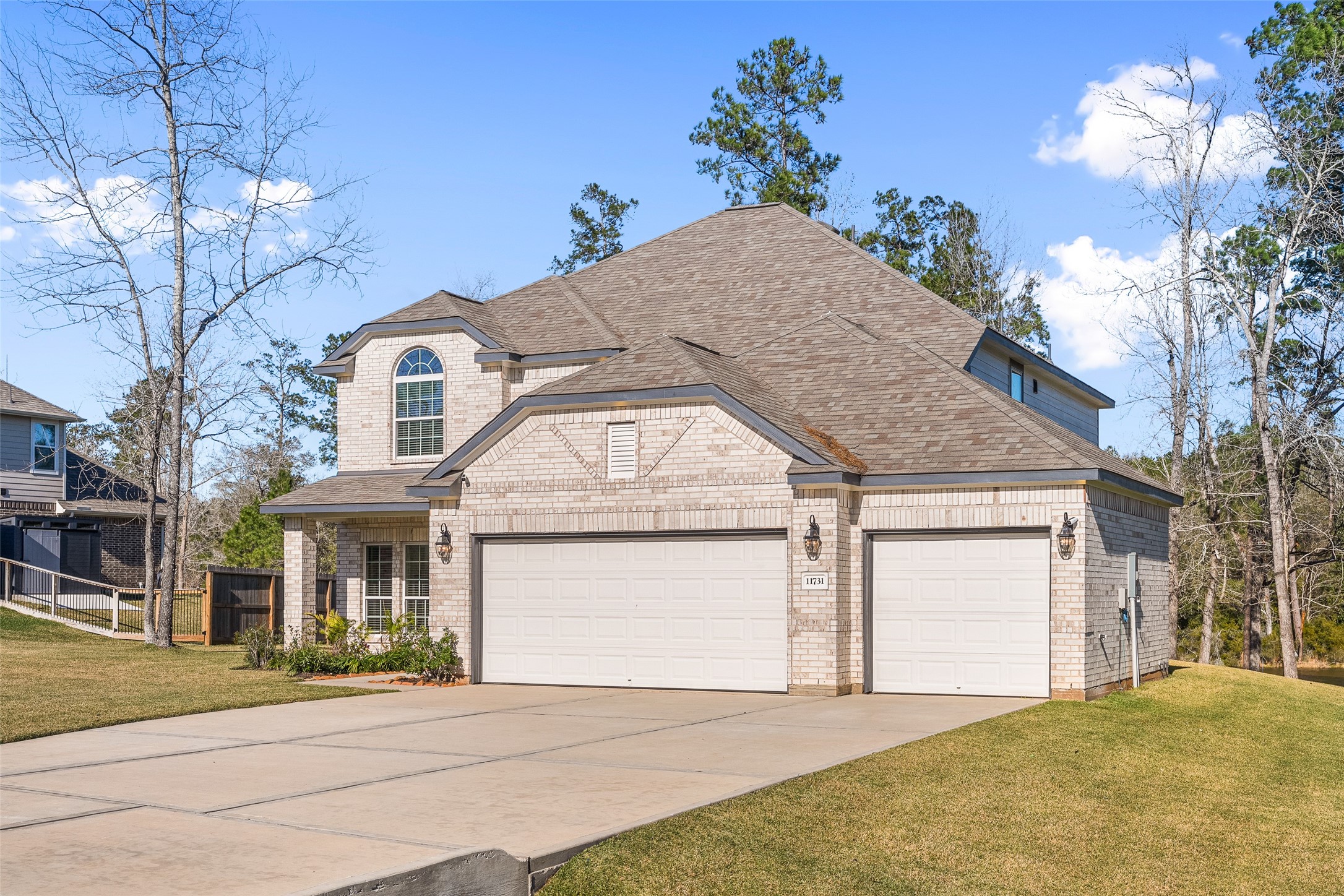 11731 Oakwood Rnch Drive Willis, TX 77378 - Photo 5 of 43 a front view of a house with a yard and garage