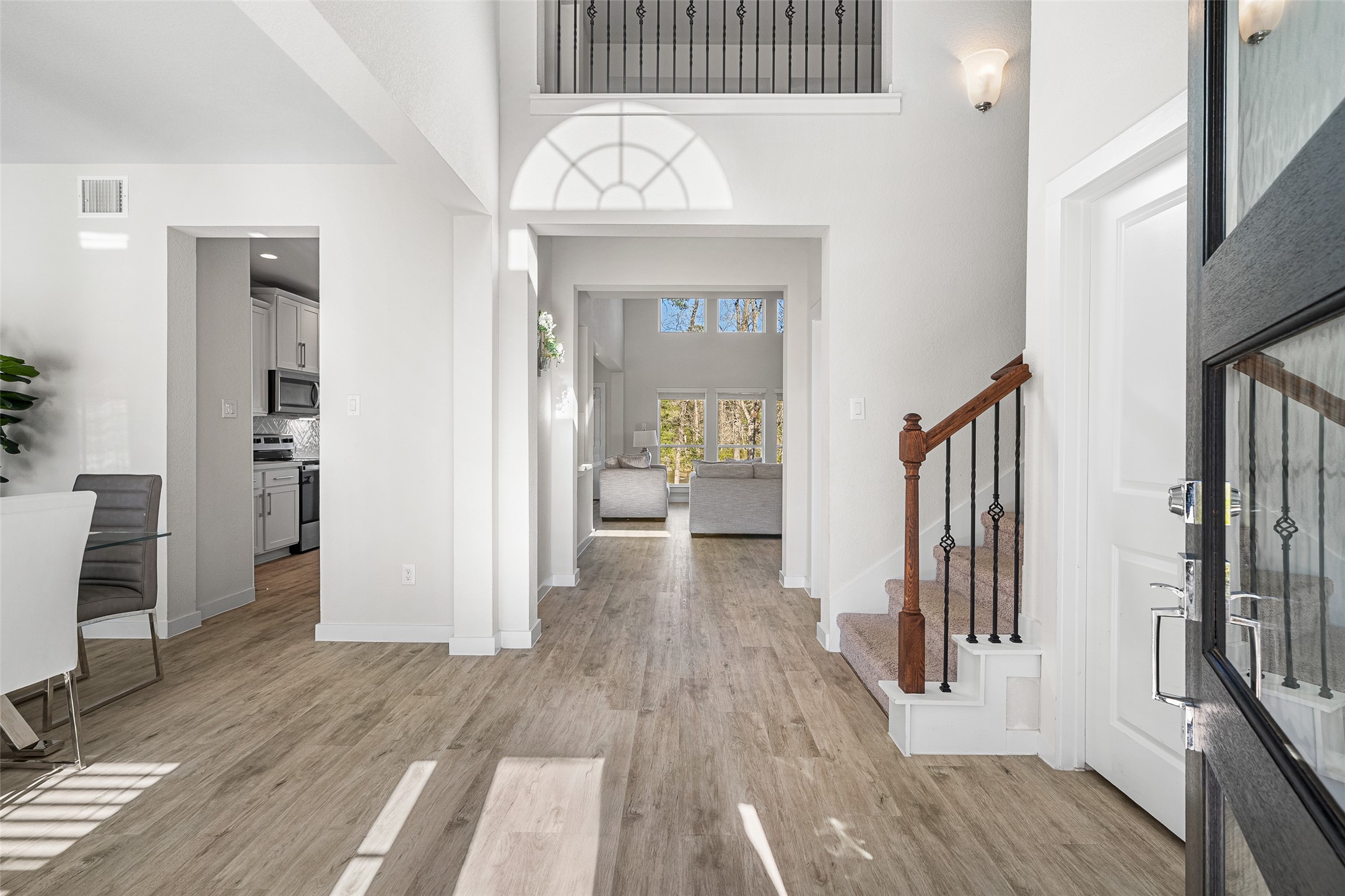11731 Oakwood Rnch Drive Willis, TX 77378 - Photo 7 of 43 a view of a hallway with wooden floor and a living room