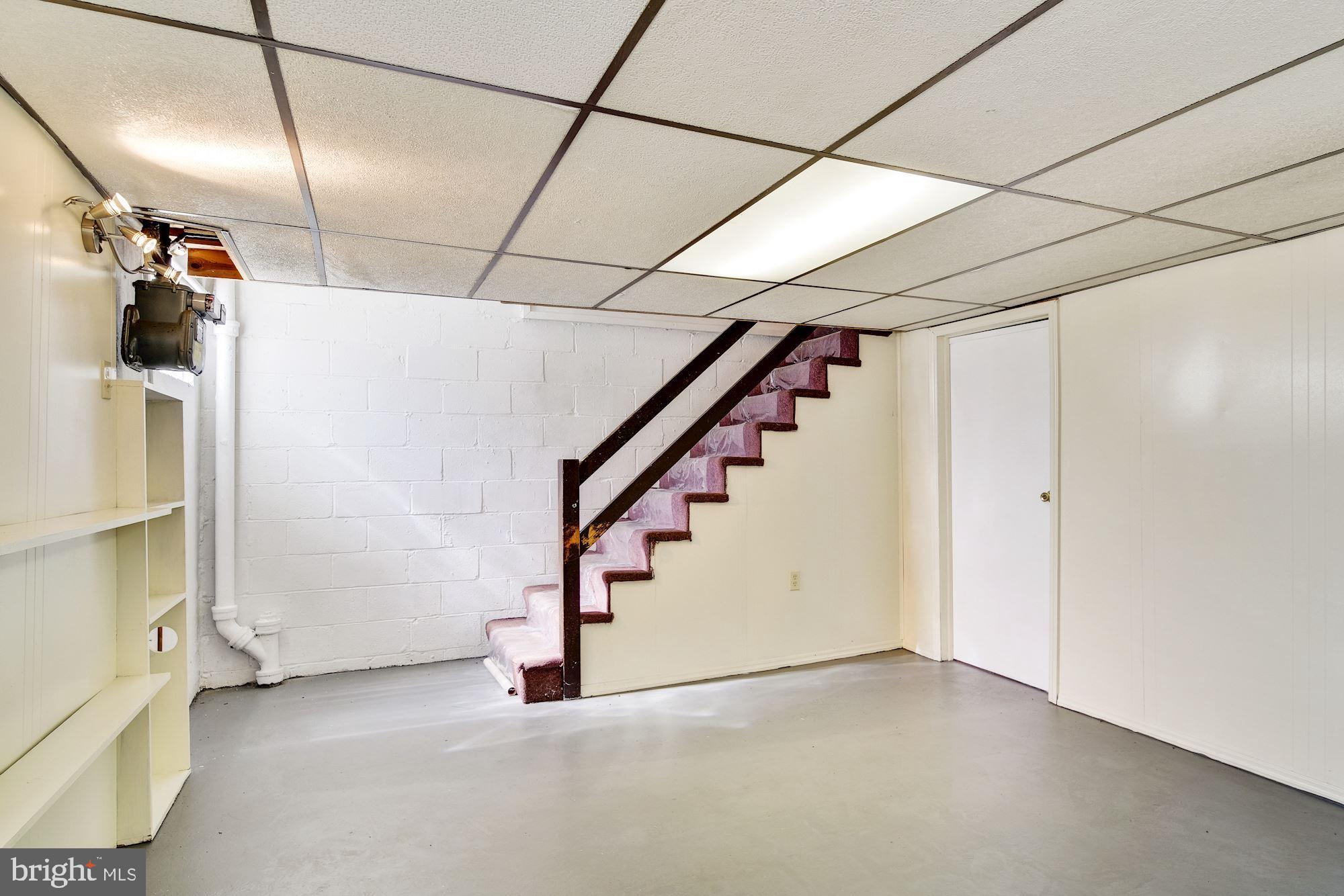 5902 Glenkirk Road Baltimore, MD 21239 - Photo 22 of 37 a view of an empty room with stairs