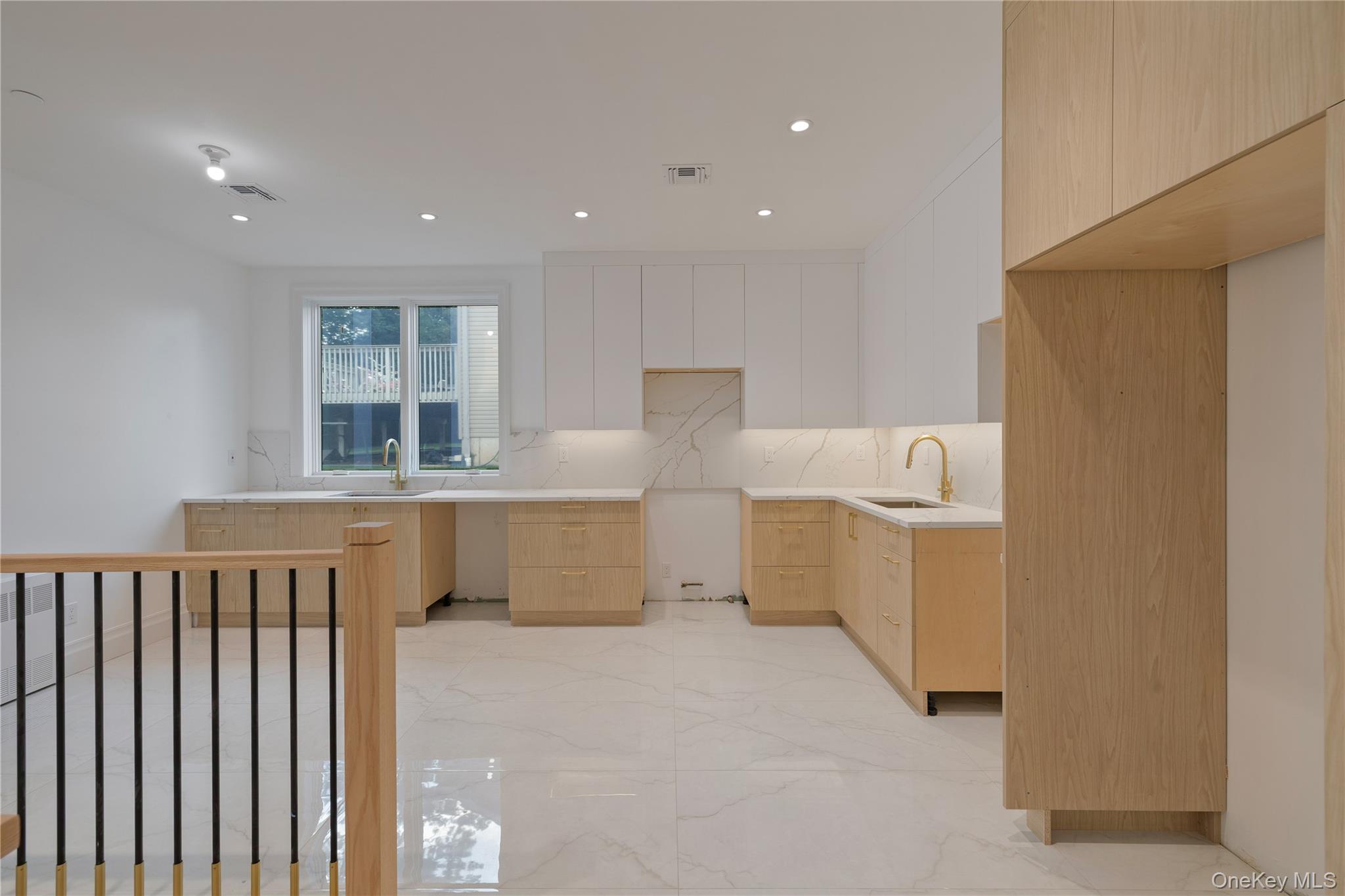 27 Ellish Parkway, Unit 112 Spring Valley, NY 10977 - Photo 8 of 24 Kitchen with light brown cabinetry, light marble finish floors, decorative backsplash, modern cabinets, and white cabinets