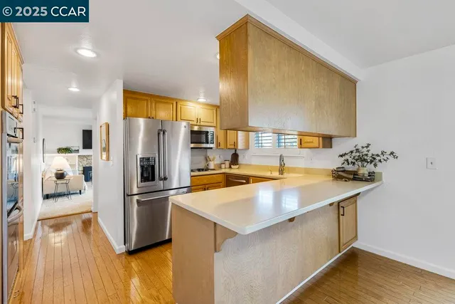 a kitchen with stainless steel appliances a sink and a refrigerator