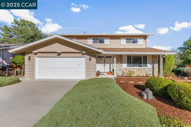 a front view of a house with a yard and porch