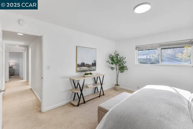 a bedroom with furniture and a potted plant