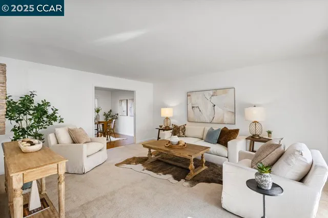 a living room with furniture and flowers