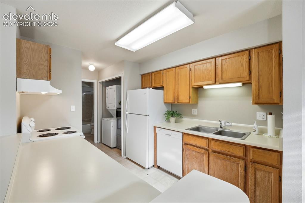 4357 Hunting Meadows Circle Colorado Springs, CO 80916 - Photo 14 of 20 a kitchen with a refrigerator sink and cabinets
