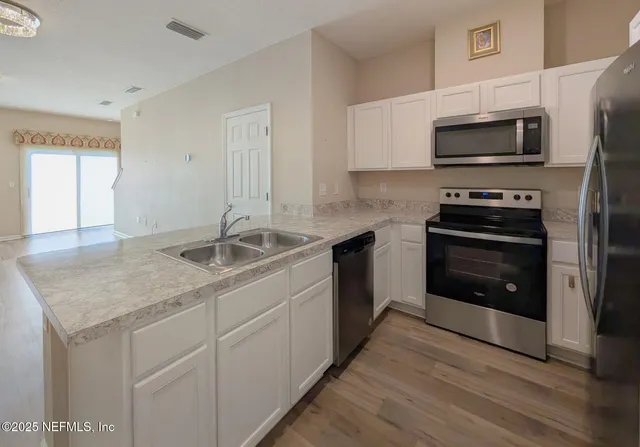 a kitchen with a sink stove and microwave